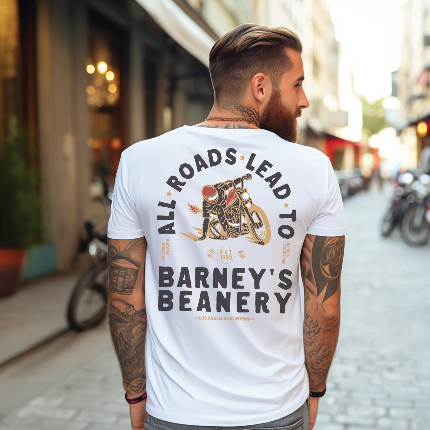 All Roads Lead To | BARNEY'S BEANERY - Men's Graphic Tee | White Bella+Canvas 3001 T-Shirt - Motorcycle Graphic On Back View Of Male Lifestyle Image