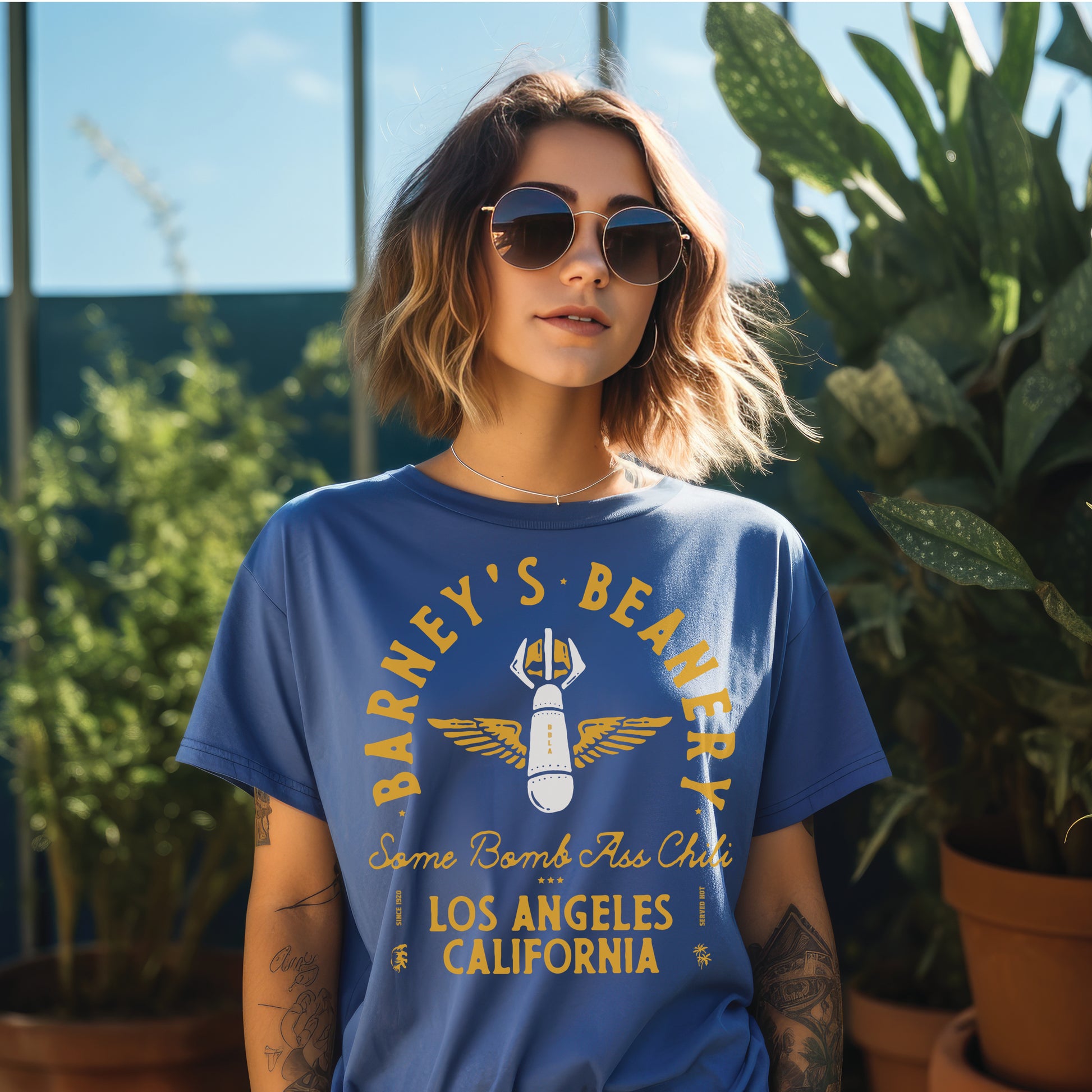 Some Bomb Ass Chili | BARNEY'S BEANERY - Women's Graphic Tee | Royal Caribe Comfort Colors 1717 T-Shirt - Big Graphic On Front View Of Female Lifestyle Image