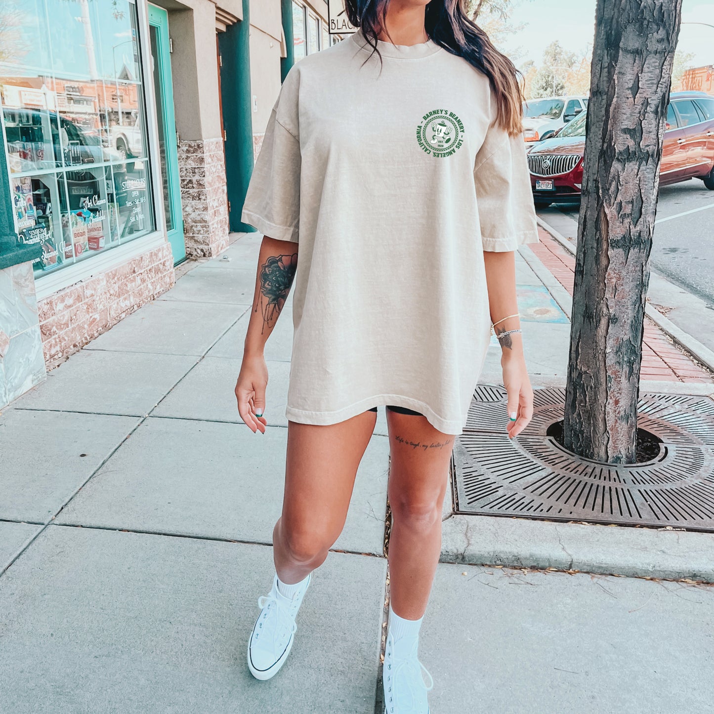 Eat More Chili. Drink More Beer. | BARNEY'S BEANERY - Women's Retro Graphic Tee | Ivory Comfort Colors 1717 T-Shirt - Green Badge Graphic On Front View Of Female Lifestyle Image