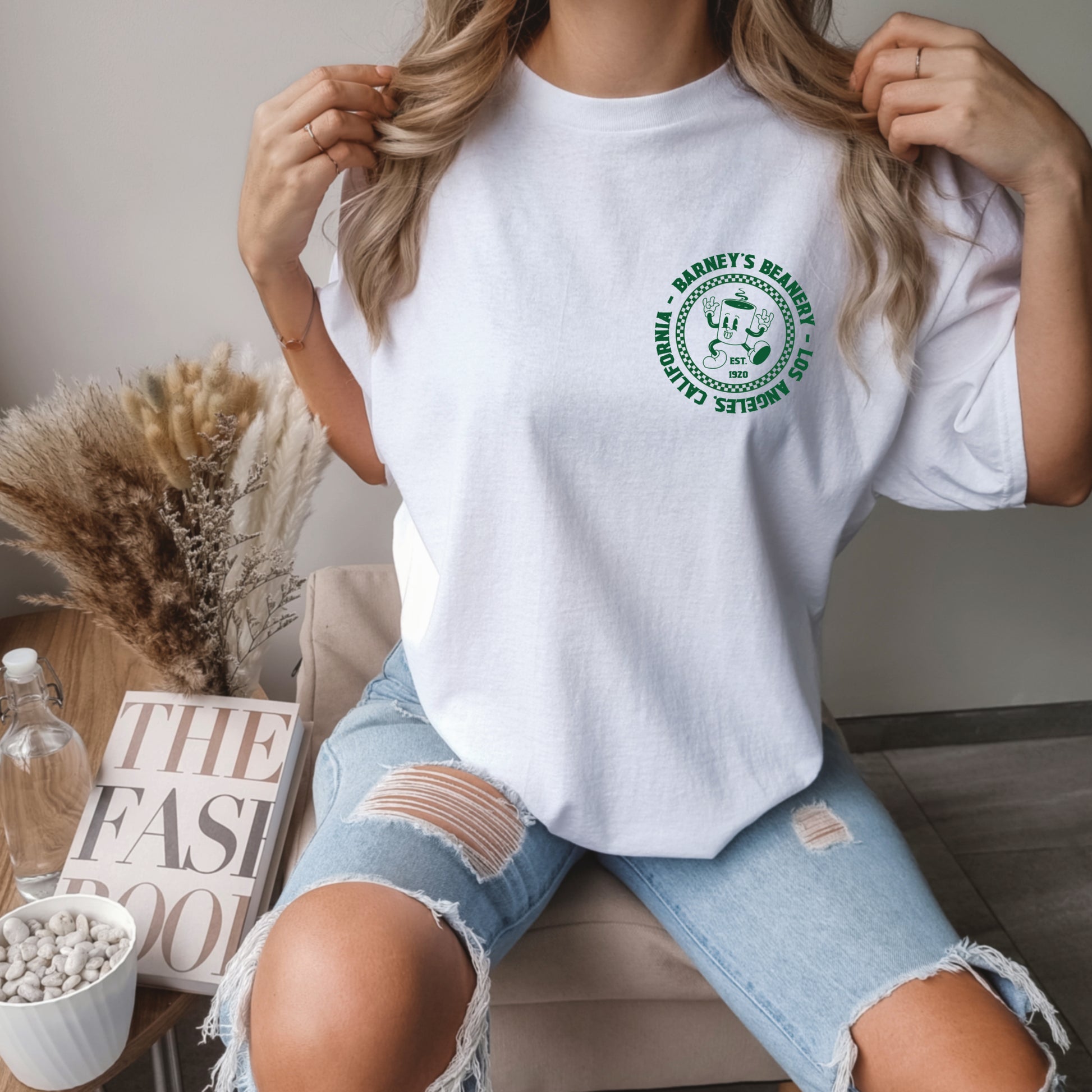 Eat More Chili. Drink More Beer. | BARNEY'S BEANERY - Women's Retro Graphic Tee | White Comfort Colors 1717 T-Shirt - Green Badge Graphic On Front View Of Female Lifestyle Image