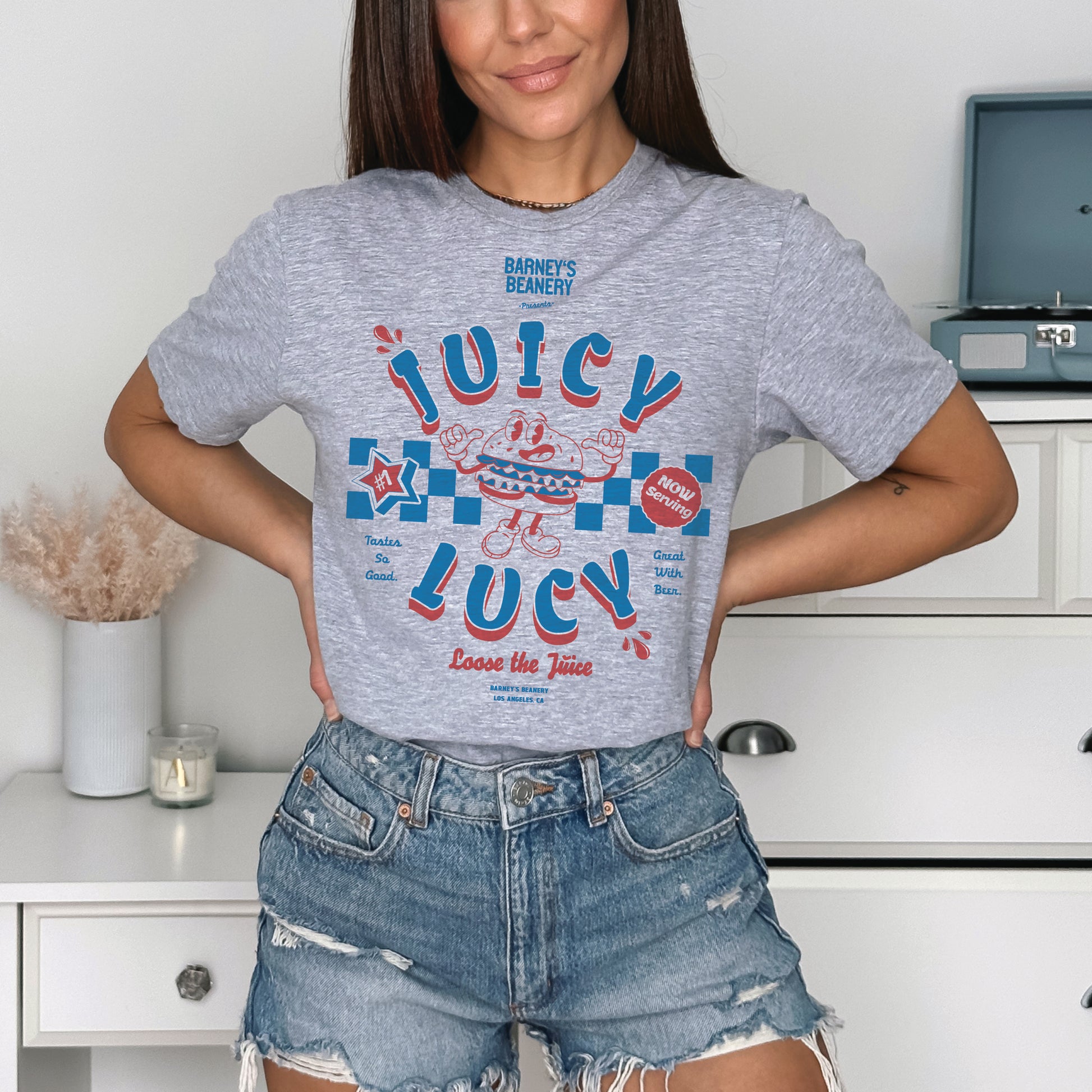 JUICY LUCY - Loose The Juice | BARNEY'S BEANERY - Women's Retro Graphic Tee | Sport Grey Gildan 5000 T-Shirt - Big Red & Blue Graphic On Front View Of Female Lifestyle Image