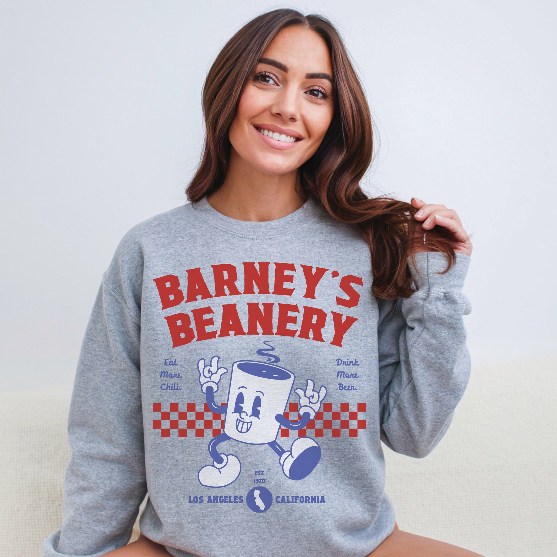 Eat More Chili. Drink More Beer. | BARNEY'S BEANERY Red & Blue - Women's Retro Graphic Sweatshirt | Red And Blue Graphics On Sport Grey Gildan 18000 Sweatshirt, Front View Female Lifestyle Image